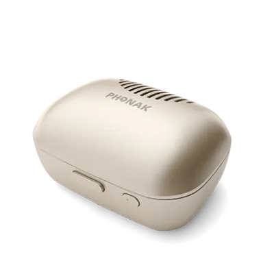 The Phonak Charge and Care is a beige, oval case with a vented lid, side button, and the Phonak logo on top, shown on a plain white background.
